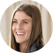 Headshot of a smiling woman with long brown hair looking slightly off camera